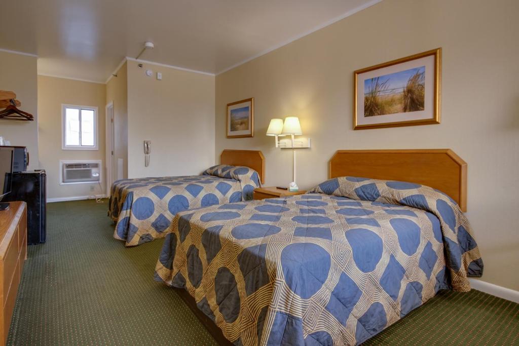 a hotel room with two beds and a television at Sahara Motel in Ocean City