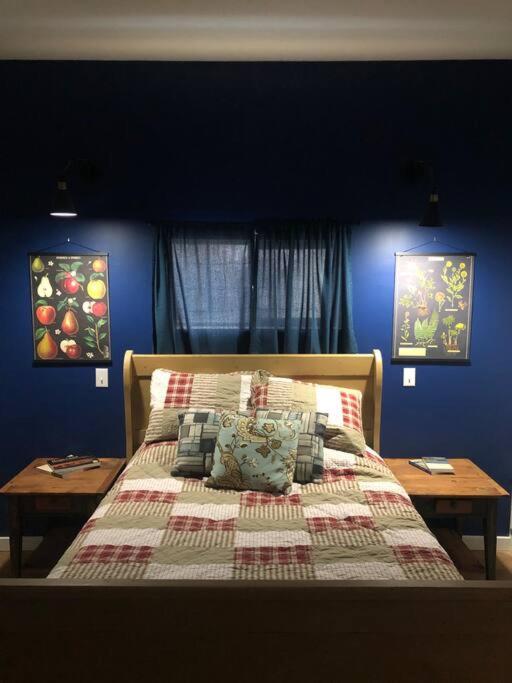 a bedroom with a bed with a blue wall at Yellowstone Hideaway in Livingston