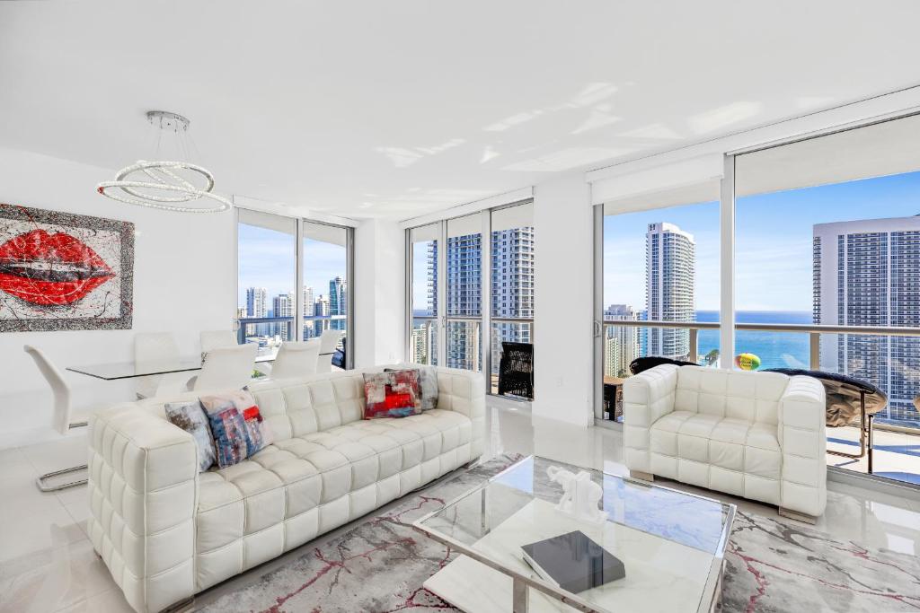 a living room with white furniture and large windows at BeachWalk Resort #2902 - WATERFRONT RESORT HOME with DIRECT OCEAN VIEW in Hallandale Beach