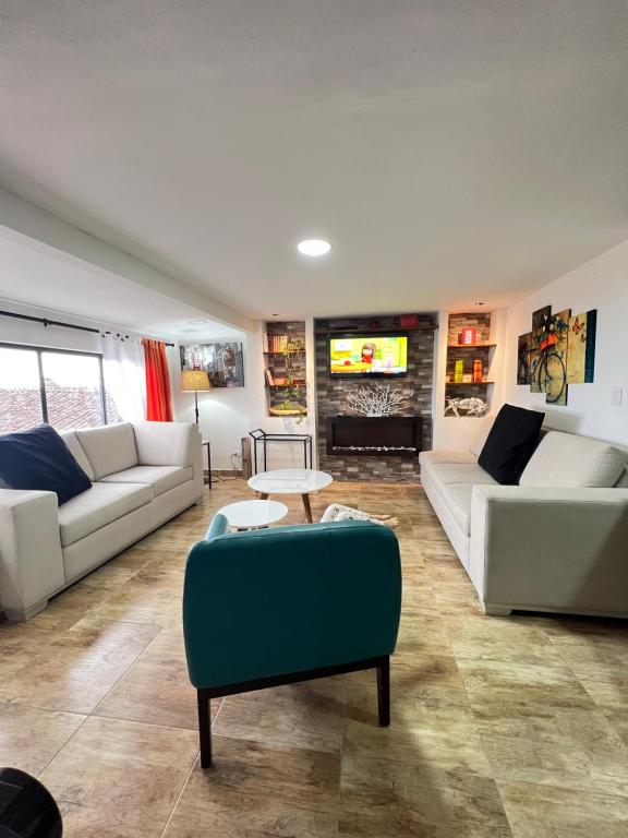 a living room with two couches and a tv at Acogedor apto en Sonsón in Sonsón