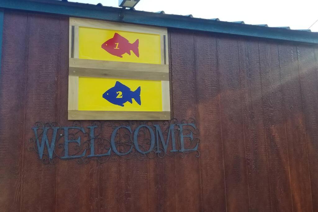 a building with two signs on the side of it at 1 FISH in Warsaw