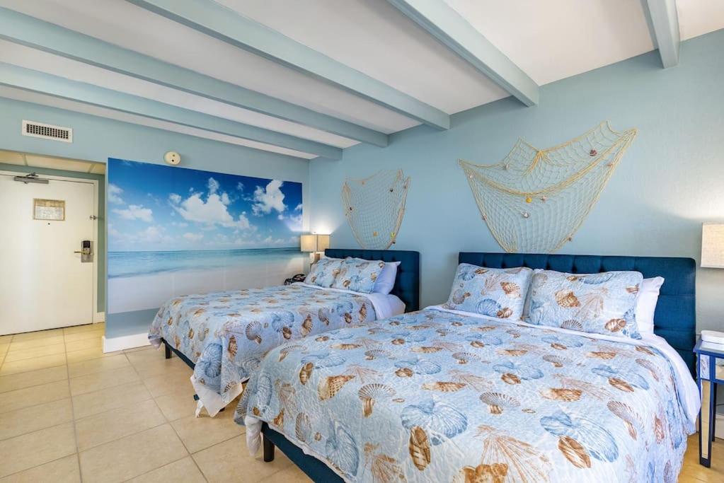 a bedroom with two beds and the ocean at Your stay on the Bay! in Ruskin