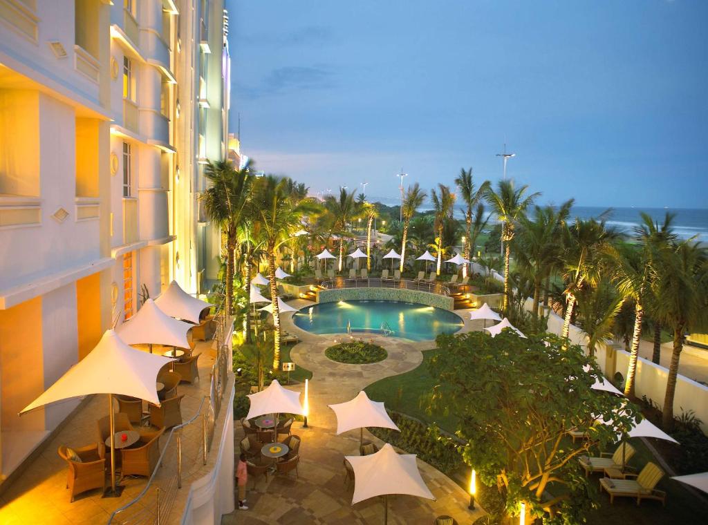 a view of a hotel balcony with a pool and umbrellas at Suncoast Hotel & Towers in Durban