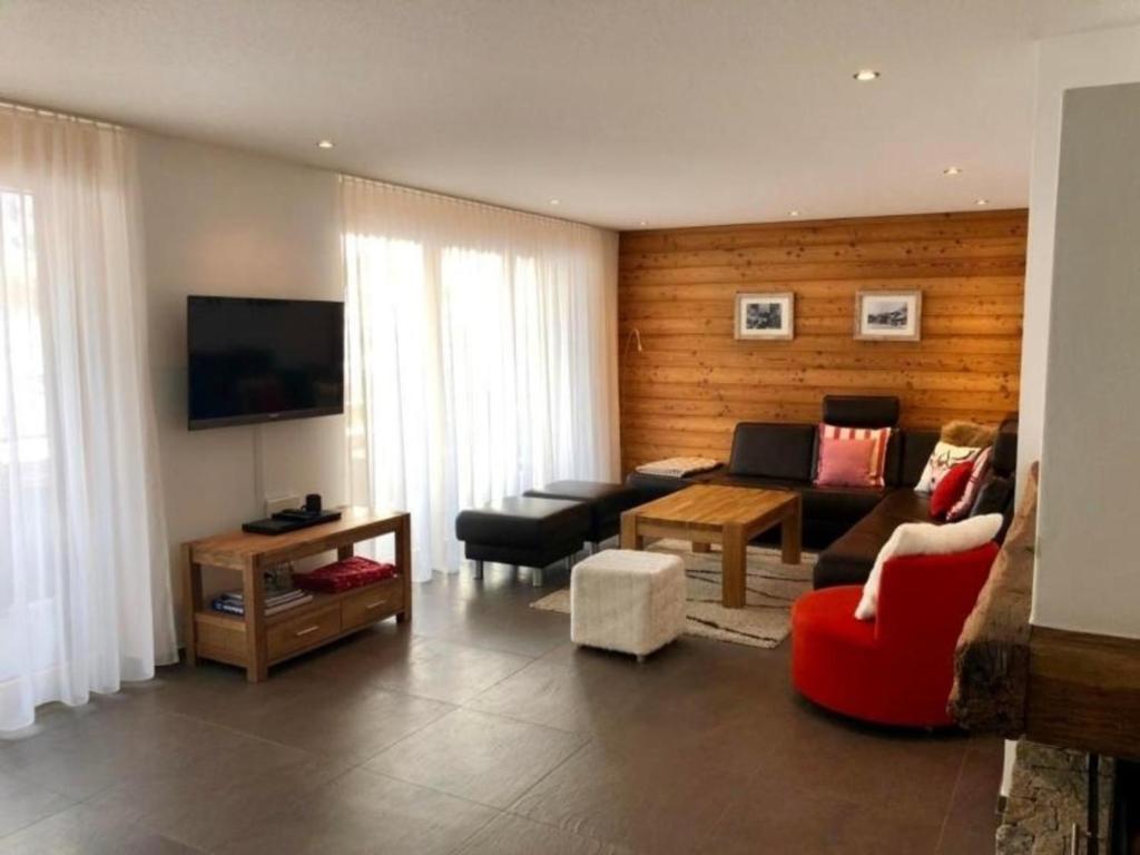 a living room with a couch and a table at Aiolos Apartments 6 Personen in Zermatt