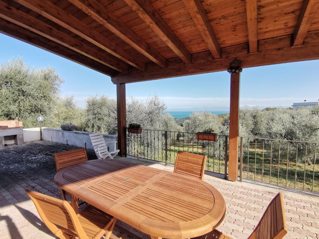 a wooden table and chairs on a patio at Tenuta Solleone in Peschici