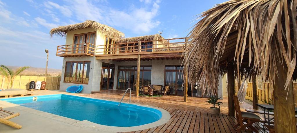 a house with a swimming pool in front of it at Casa Villa Alive - Vichayito Sur, Los Organos Talara in San Martín