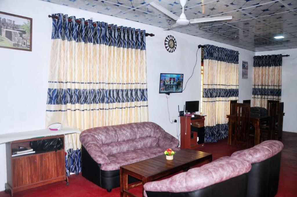 - un salon avec un canapé et une table dans l'établissement Impress Holiday Home, à Anurâdhapura