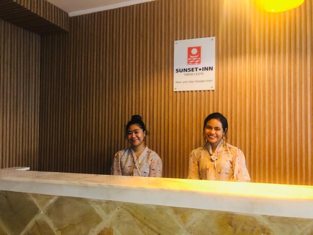 two women are standing in front of a counter at Sunset INN by Pro-Ema in Dili