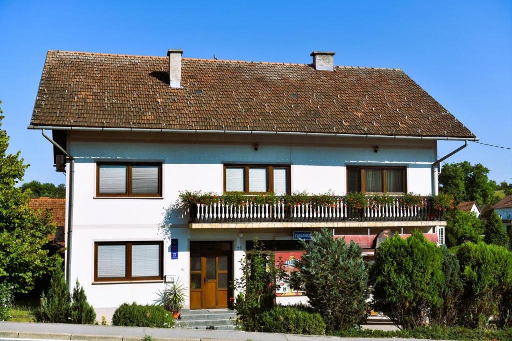 a white house with a brown roof at Apartments and rooms with parking space Rakovica, Plitvice - 20647 in Rakovica