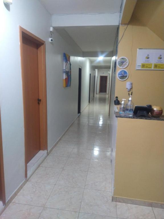 an empty hallway with a hallway leading into a room at Hotel 678 in Boa Vista