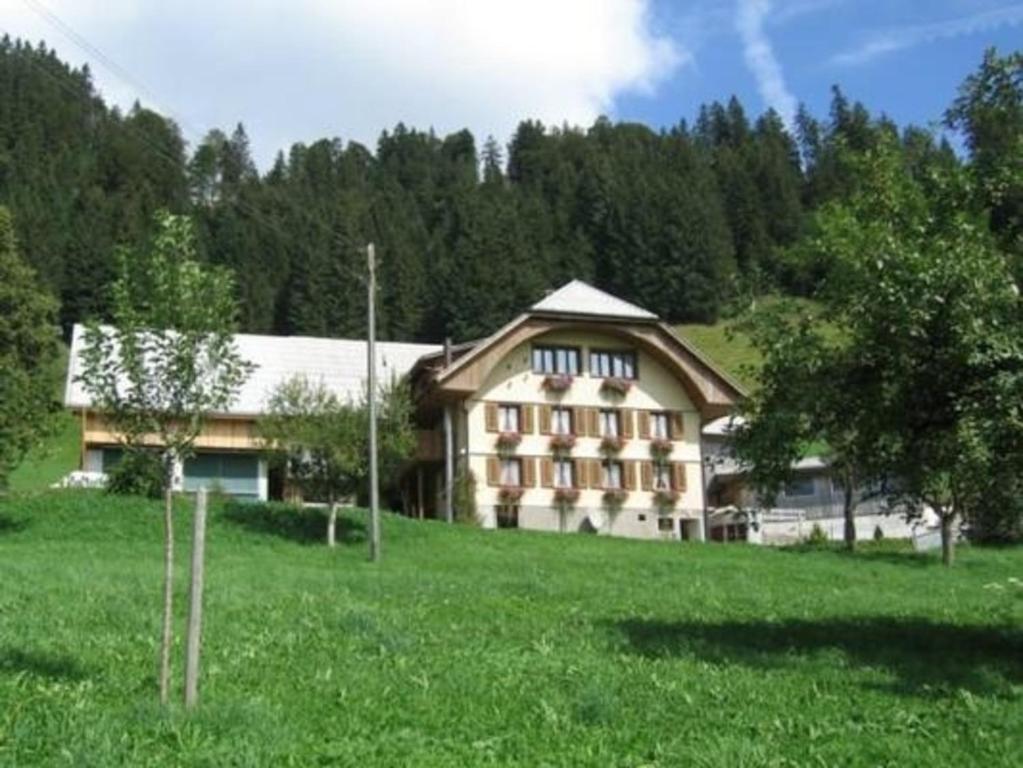 a large building in the middle of a field at Balm in Escholzmatt