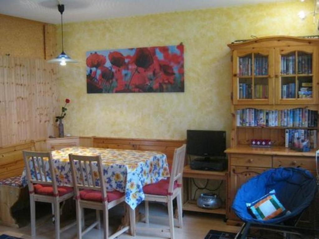 a dining room with a table and chairs at Haus Rhoneblick in Leukerbad