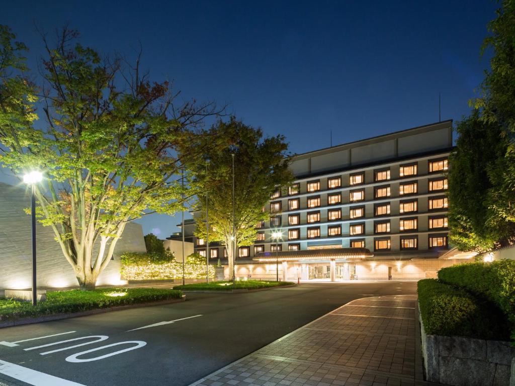 ein beleuchtetes Gebäude mit einer Straße in der Nacht in der Unterkunft Kyoto Brighton Hotel in Kyoto