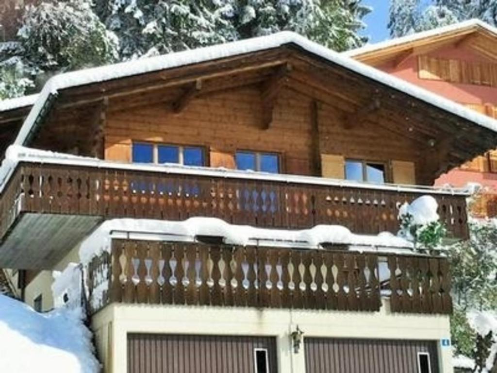a house with a deck covered in snow at Seeblick Fraissen in Laax