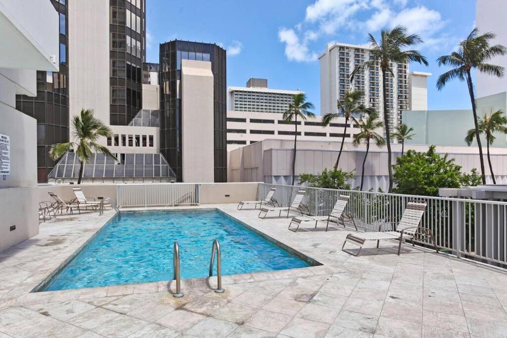 a swimming pool on the roof of a building at Modern Studio - Heart of Waikiki with Parking! in Honolulu