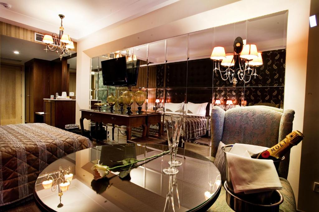 a living room with a couch and a glass table at Danai Hotel & Spa in Olympic Beach