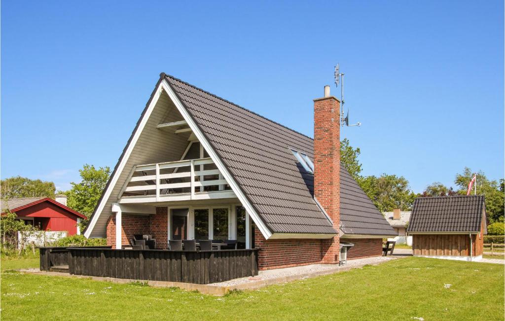 a house with a gambrel roof with a brick chimney at Gorgeous Home In Samsø With Kitchen in Onsbjerg