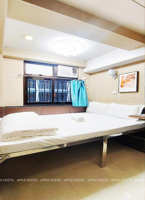 Letto o letti in una camera di Apple Hostel 蘋果賓館