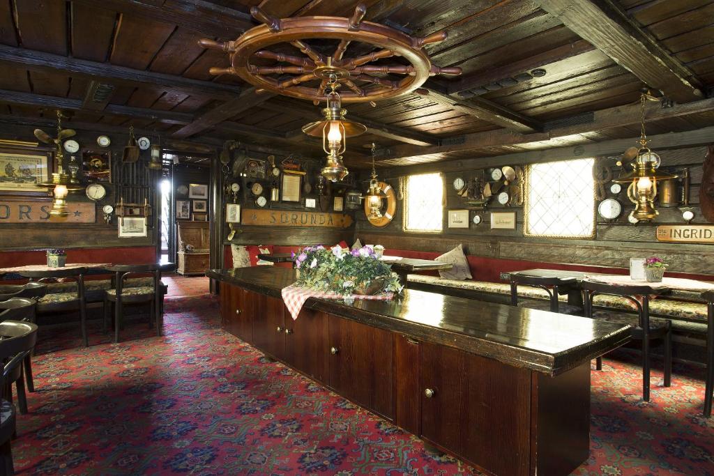 a large room with a bar in a restaurant at Den Röda Båten in Stockholm