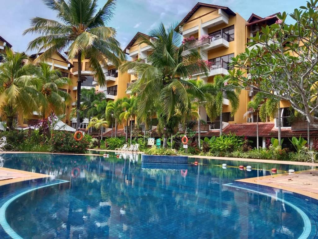 a swimming pool in front of a resort at Tiara Labuan Hotel in Labuan