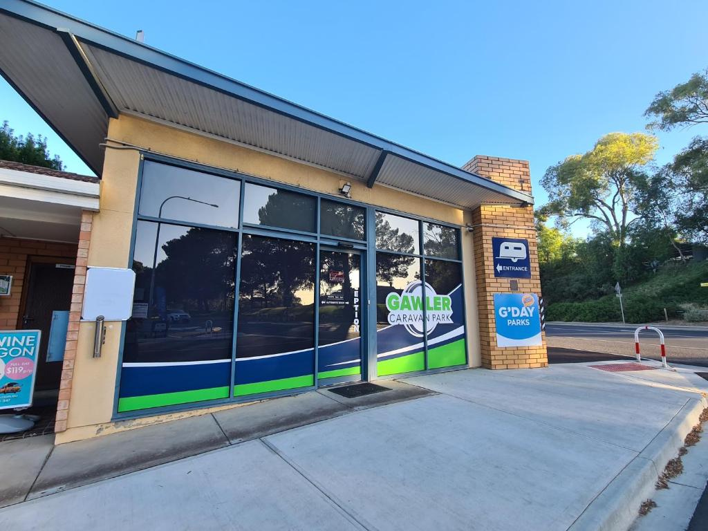 a store front with glass windows on a street at Gawler Caravan Park in Gawler