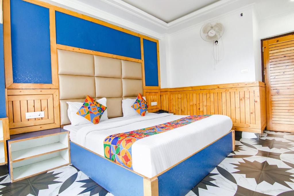 a bedroom with a large bed in a room at FabHotel Rosewood Inn I in Dharamshala