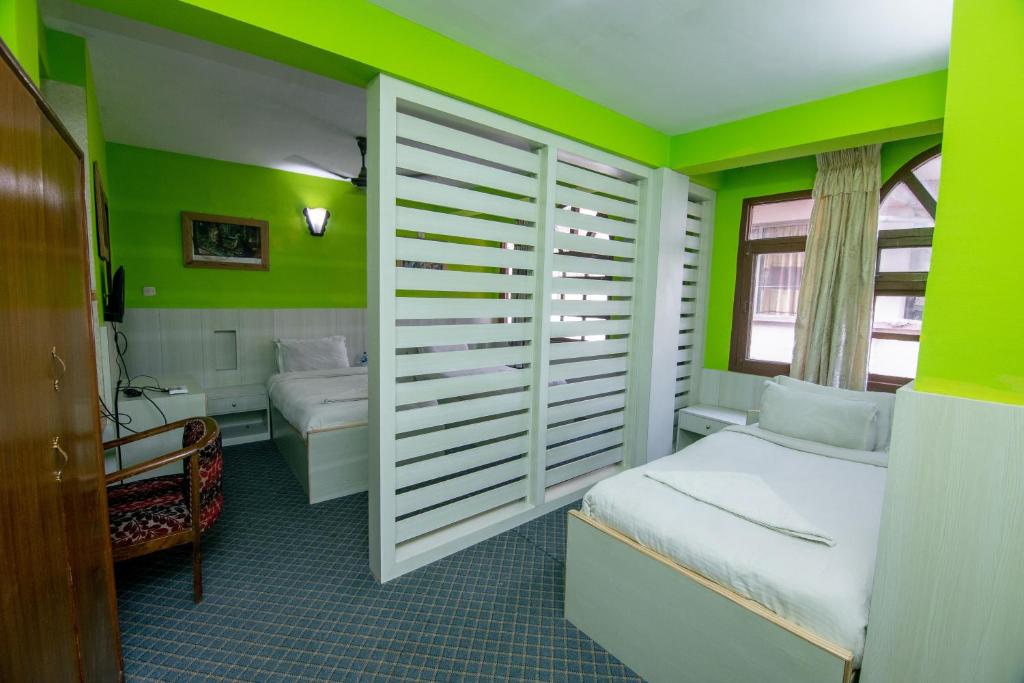 Postel nebo postele na pokoji v ubytování Hotel Pomelo House