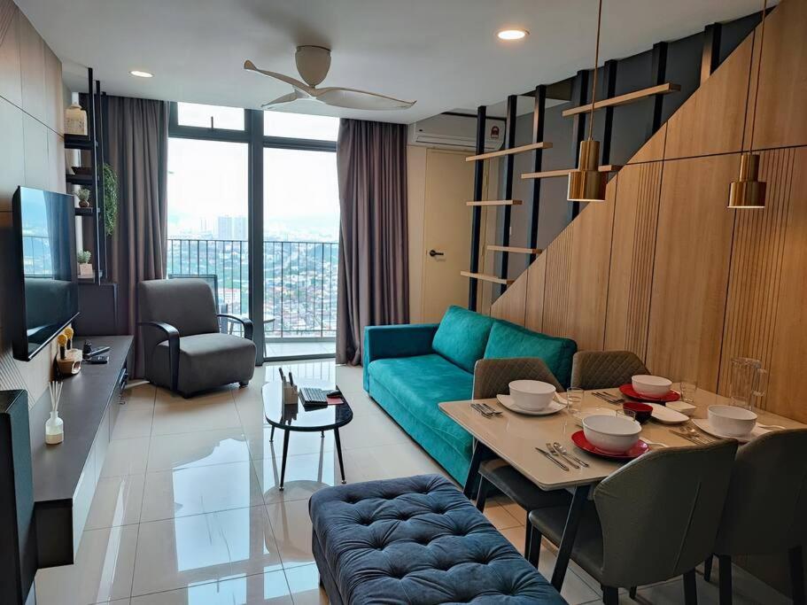 a living room with a blue couch and a table at ekocheras duplex suites with balcony, drinking water, Karaoke K in Kuala Lumpur