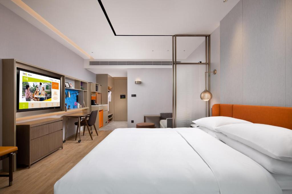 Postel nebo postele na pokoji v ubytování Home2 Suites by Hilton Chongqing Yubei