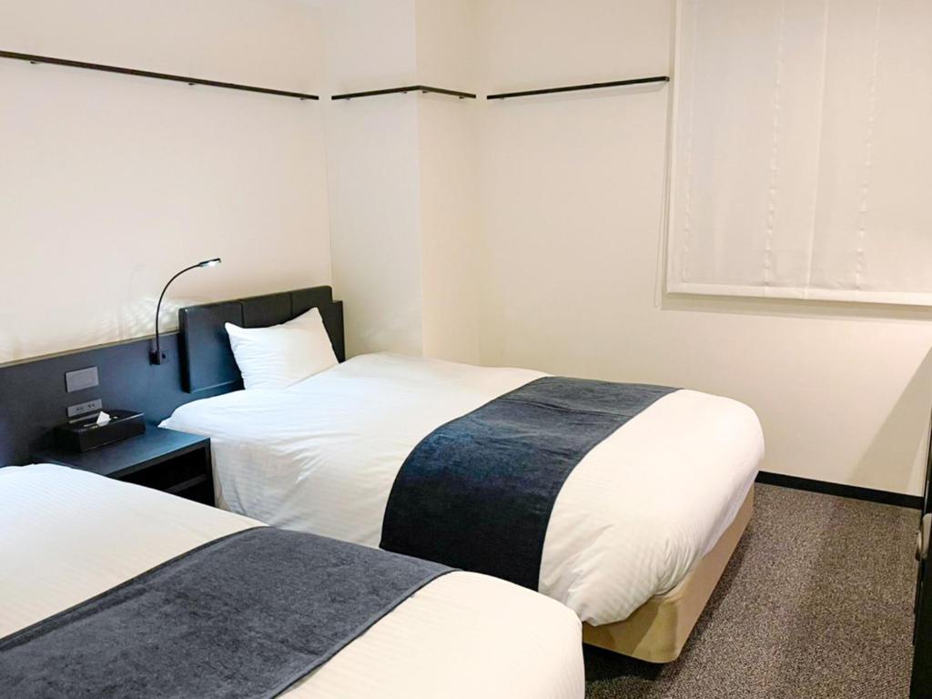 Postel nebo postele na pokoji v ubytování HOTEL SUI KANDA by ABEST