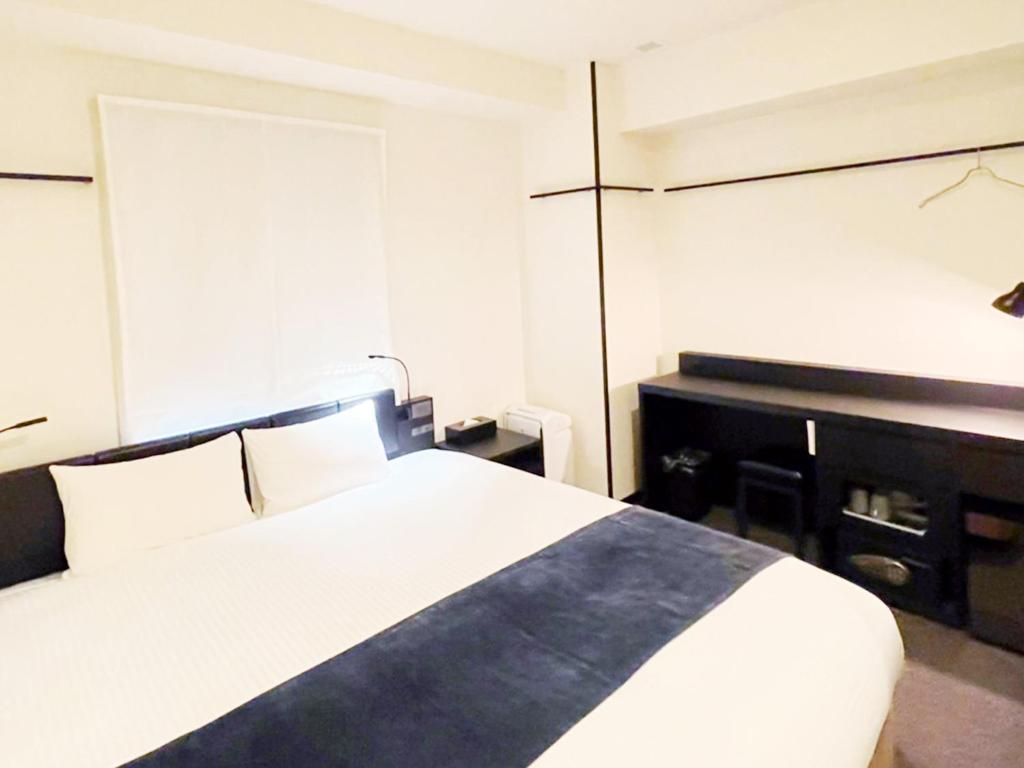 Postel nebo postele na pokoji v ubytování HOTEL SUI KANDA by ABEST
