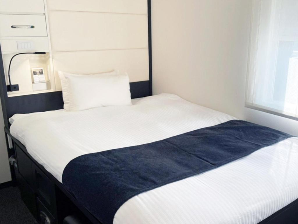 Postel nebo postele na pokoji v ubytování HOTEL SUI KANDA by ABEST