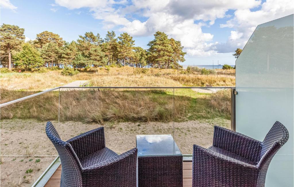 a patio with two chairs and a table on a balcony at Diamond in Binz