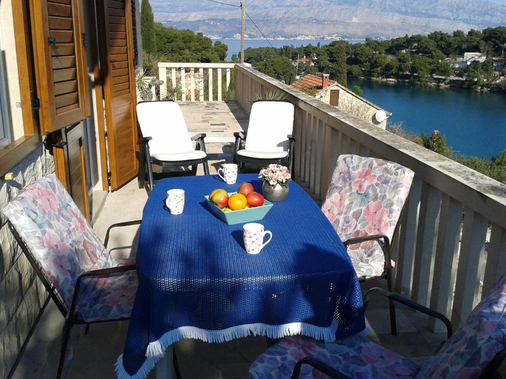 a table with a bowl of fruit on a balcony at Apartment Splitska in Splitska