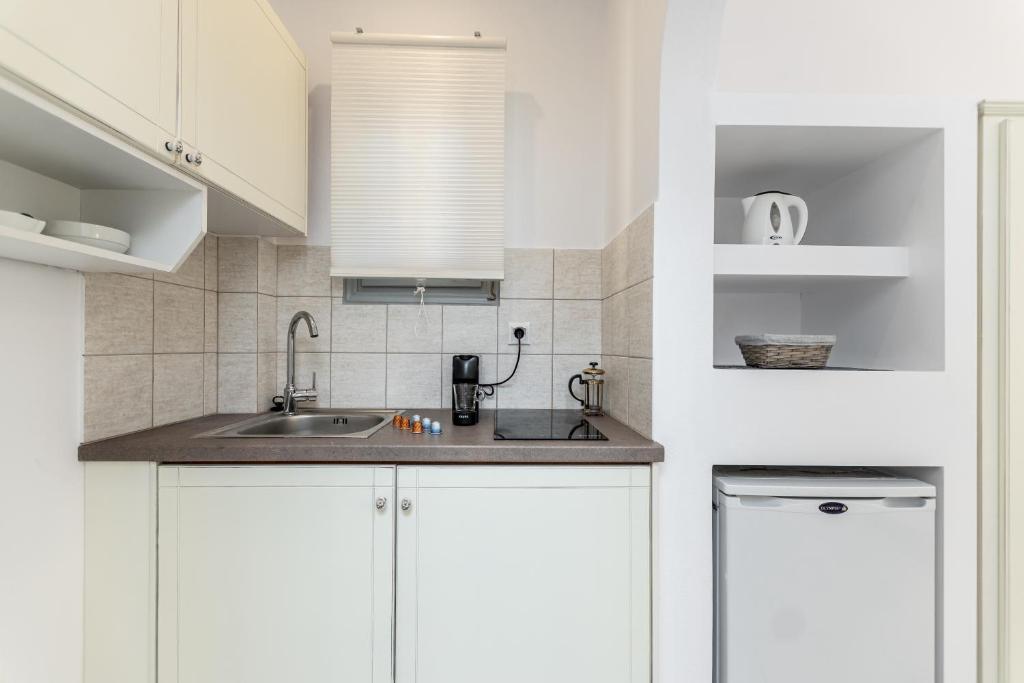 Kuchyň nebo kuchyňský kout v ubytování Zanneta Apartments & Suites