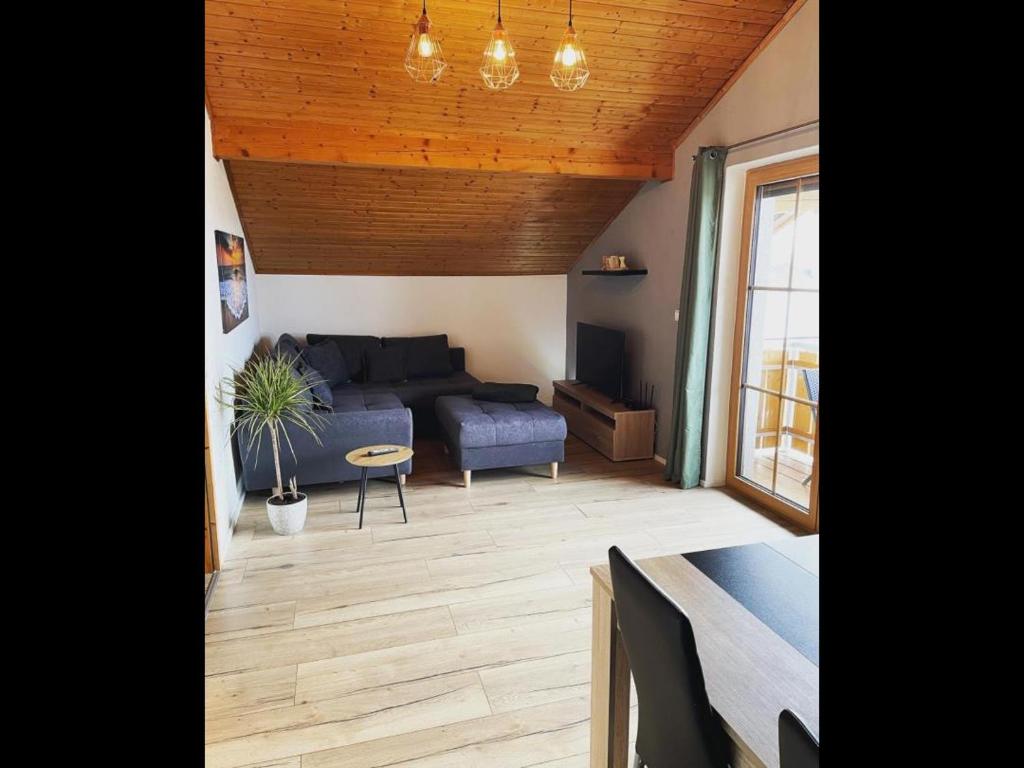 a living room with a couch and a table at NEU! FeWo Mansi in Chiemgau in Kienberg