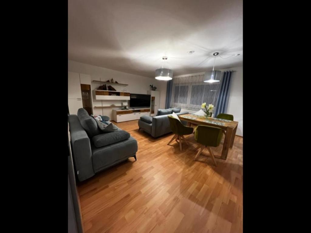 a living room with two couches and a dining table at NEU! Ferienwohnung Feuergasse 