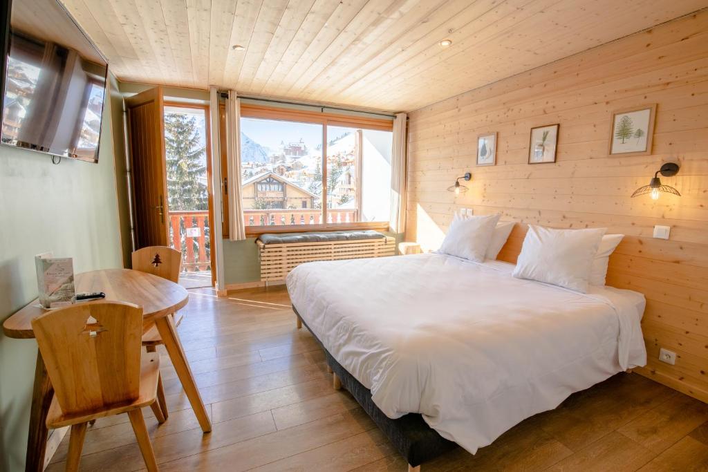 Postel nebo postele na pokoji v ubytování Hotel Les Lutins