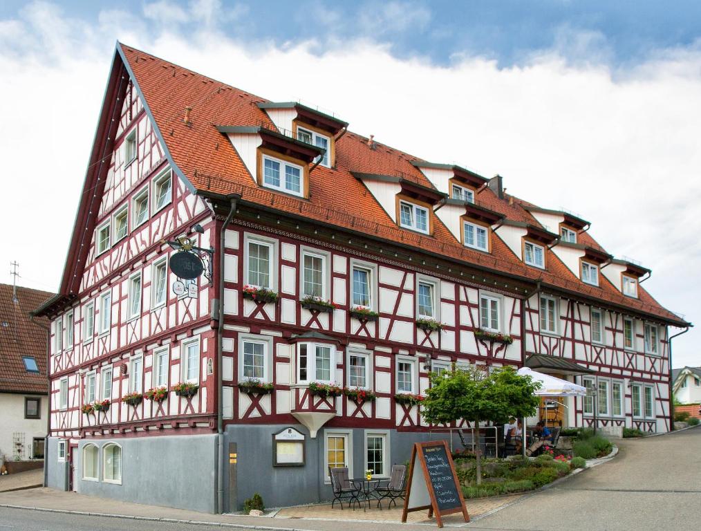 un gran edificio con techo rojo en Hotel Post Jungingen, en Jungingen