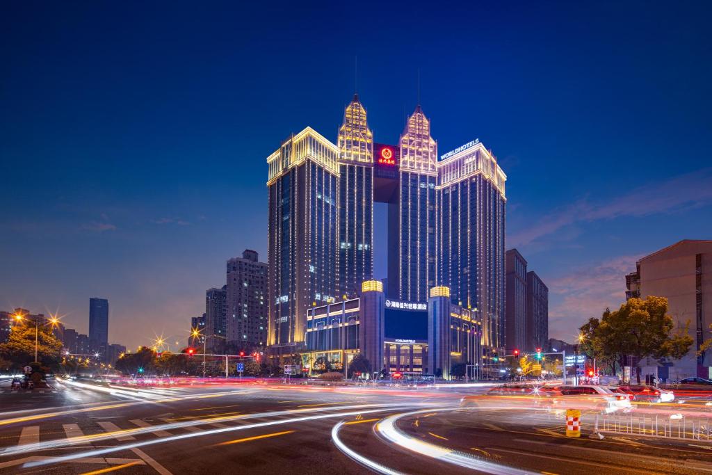 a city skyline at night with traffic on a street at WorldHotel Grand Jiaxing Hunan in Changsha