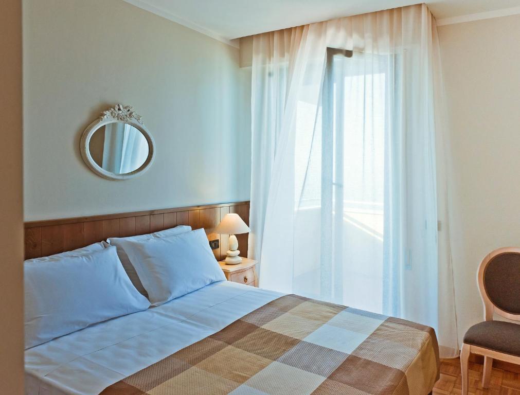 Postel nebo postele na pokoji v ubytování Hotel Ambassador