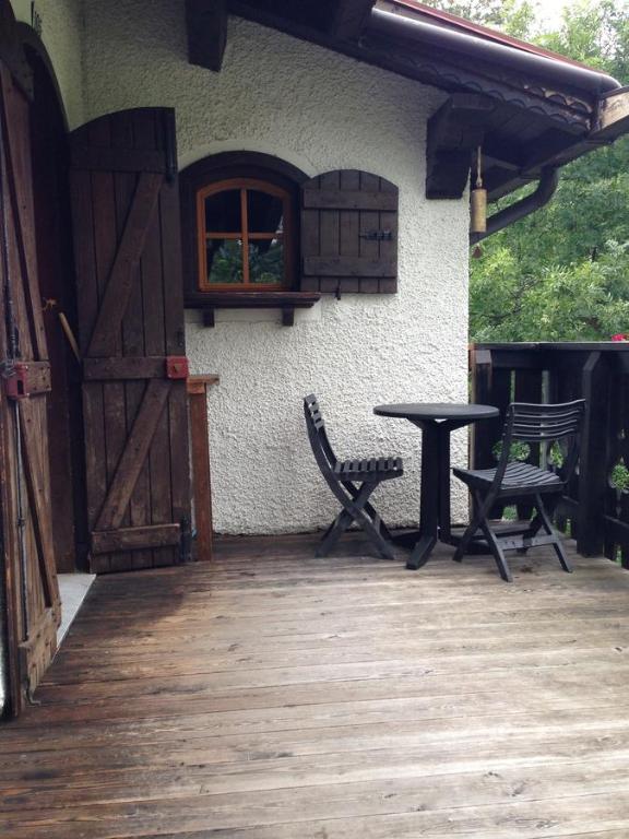 a patio with two chairs and a table and a window at Appartamento Scoiattolo in Folgaria