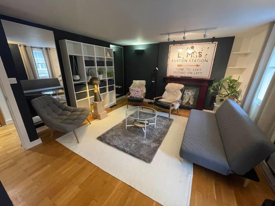 a living room with a couch and a table at Stylish flat next to King's Cross Station in London