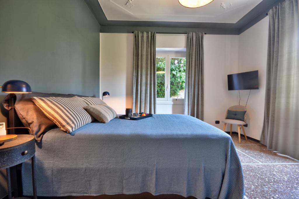um quarto com uma cama azul e uma janela em Cosy Home Riviera Wi-fi, AC, terrace 3 BDR em Chiavari