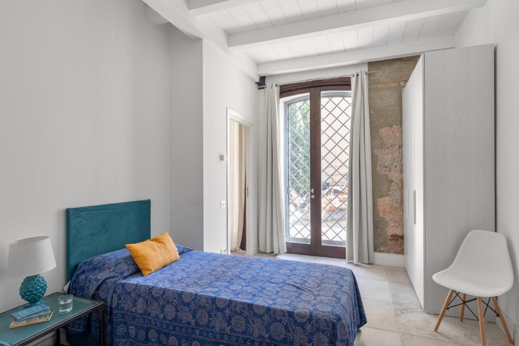 A bed or beds in a room at Valverde Art Space Loft by DomuSicily