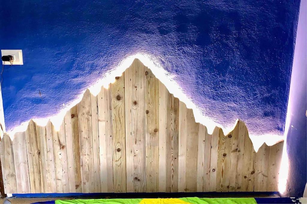 a wooden fence in front of a blue ceiling at Accogliente appartamento in centro in Frabosa Soprana