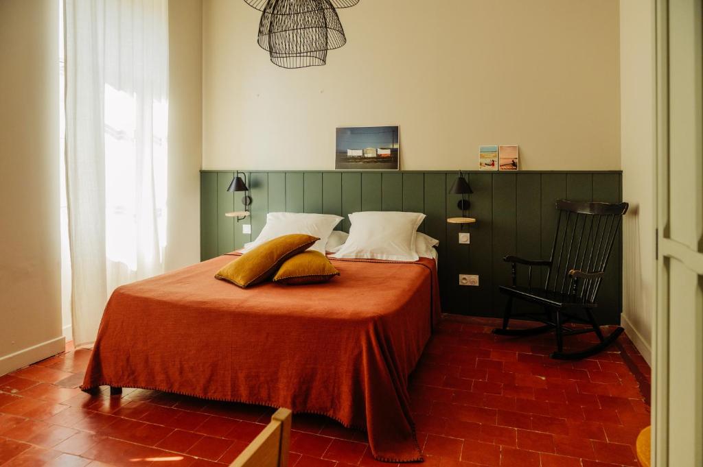 a bedroom with a bed with two pillows on it at La Maison de Gruissan in Gruissan