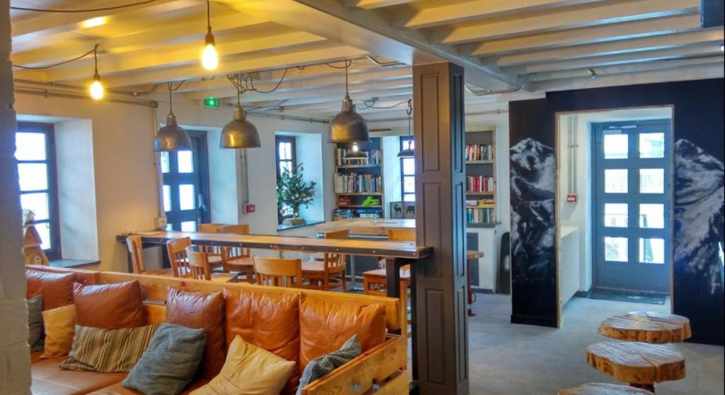 a dining room with orange chairs and a table at CHALET AUBERGE - Les Mélèzes in Tignes