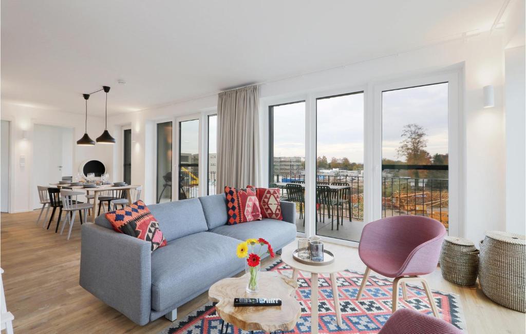 a living room with a blue couch and a table at Beach Front Apartment in Lembruch