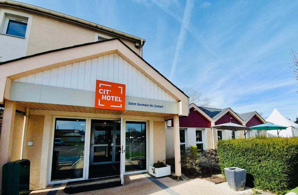 a gift store with a sign in front of it at Cit'hotel Design Booking Evry Saint-Germain-lès-Corbeil Sénart in Saint-Germain-lès-Corbeil
